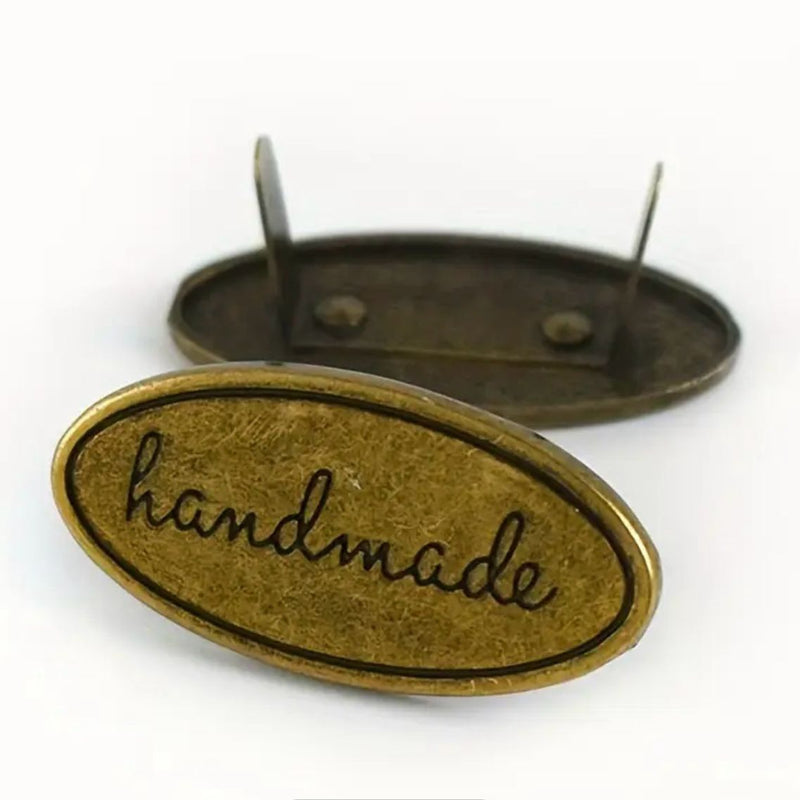 HARDWARE ACCESSORY: Set of 3 Oval (approx 1½" long) "Handmade" Metal Brads / Charms in antique colour